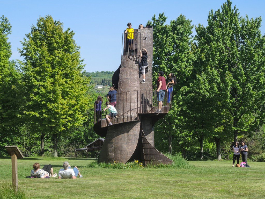 People climbing the "tower" at Griffis Sculpture Park in the summertime