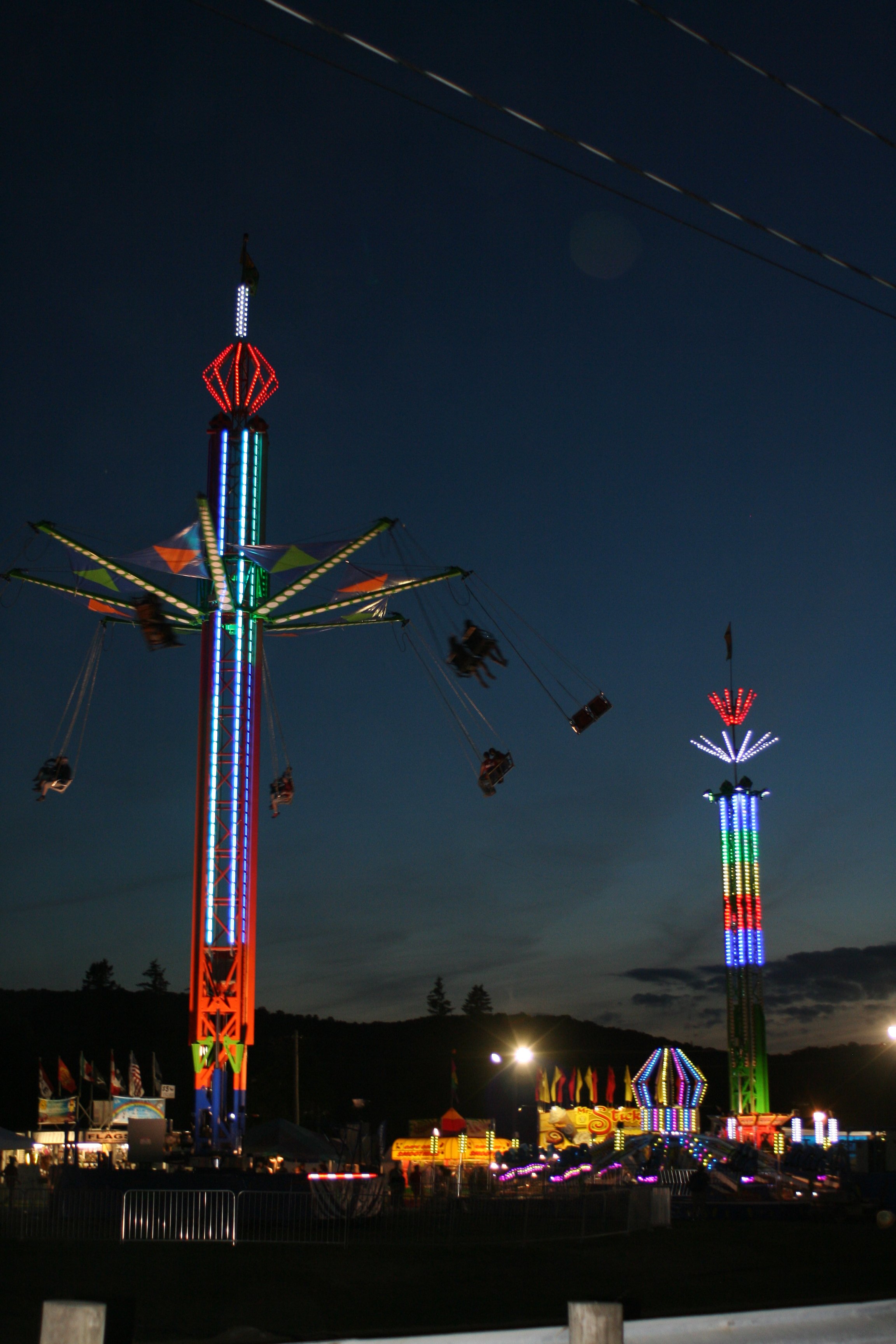Sky view of neon lights on the rides along the midway at the Cattaraugus County Fair